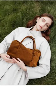 Brown suede pillow bag detail shot, vintage autumn winter shoulder handbag for women commute.