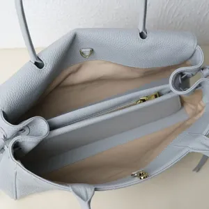 Light blue leather tote bag, large capacity commute shoulder bag with interior compartment.