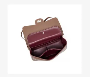 Detailed view of the brown leather shoulder bag interior, featuring multiple internal compartments.