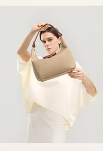 Stylish beige nylon shoulder bag for women, classic hobo dumpling tote with leather handle.