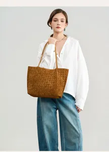 Detailed view of brown suede woven tote bag, elegant women casual shoulder bag style.