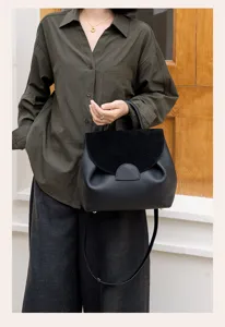 Black genuine leather shoulder handbag with suede flap for women commute daily use style.