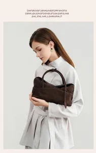 Detailed view of women retro brown suede pillow bag, elegant commuting style handbag.