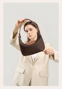 Brown nylon hobo dumpling shoulder bag detail view showcasing leather handle and flap.