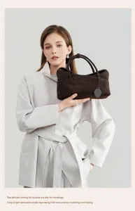 Detailed view of the vintage brown suede pillow handbag, showcasing soft texture and elegant design.