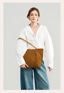 Close-up detail of brown suede woven shoulder tote bag, large capacity underarm design.