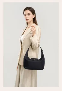 Detailed view of black nylon hobo shoulder bag, showing quality fabric and hardware.