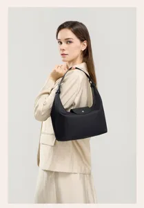 Black nylon shoulder bag underarm hobo dumpling bag with leather flap casual commuter purse.