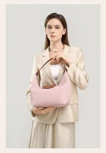 Chic pink nylon shoulder bag with brown leather handles and flap, elegant commuting handbag.