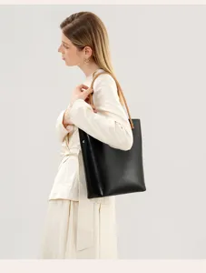 Classic black leather tote bag with camel handles, stylish shoulder bag for daily commute.