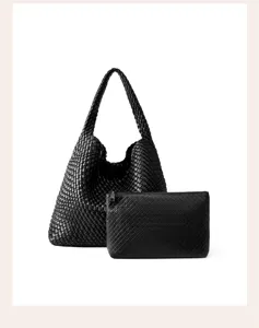 Detailed view of black woven leather shoulder bag and matching pouch, premium texture design.