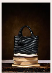 Detailed view of luxury black woven leather handbag showing exquisite craftsmanship and texture.