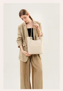 Detailed view of the women's woven leather tote bag showcasing its spacious design and style.