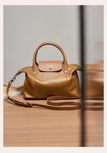Brown genuine leather top handle shoulder bag, niche design stylish pillow bag for women daily use.