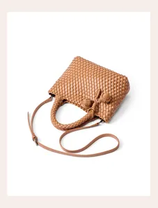 Brown woven leather shoulder bag with chic knot handle design for daily commuting.