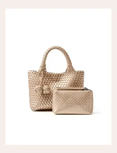Detailed close-up of a metallic gold woven leather tote handbag and matching small zip pouch.