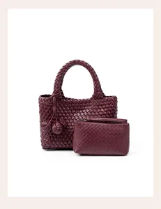 Detailed view of the dark red handmade woven leather tote bag with a matching pouch and knots.