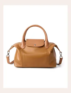 Brown genuine leather handbag detail, soft texture and exquisite metal hardware finish.