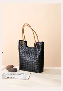 Classic woven leather tote bag with comfortable tan handles, spacious design for daily use.