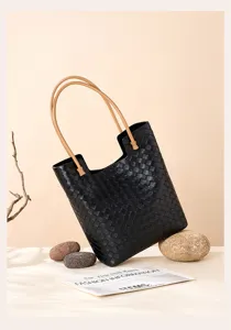 Black woven leather tote bag with tan handles, large capacity retro shoulder bag detailed view.