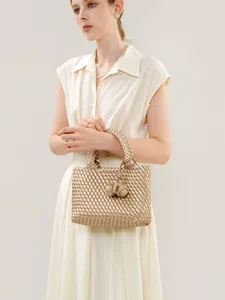 Elegant metallic gold woven handbag with unique knot design for women stylish daily commute.