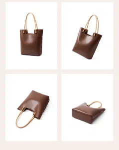 Detail view of brown leather tote bag, large capacity vintage shoulder handbag for women.