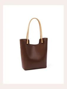 Brown leather tote bag detail, featuring contrast handles, large capacity, vintage shoulder style.