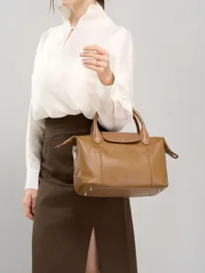 Brown leather handbag for women, top layer cowhide shoulder bag with top handle and flap design.