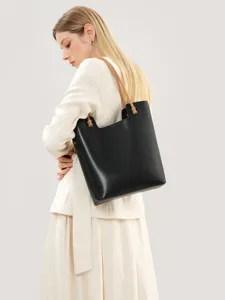 Classic black leather tote bag for women with elegant brown shoulder straps and spacious capacity.