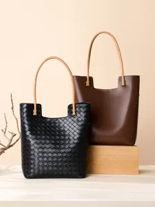 Stylish women's woven leather tote bag with large capacity and retro shoulder strap design.