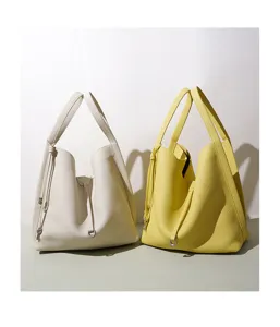 Minimalist leather tote bag detail, chic bucket style handbag with lock, elegant daily commute accessory.