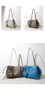 Korean style cowhide shoulder bag detail, elegant large capacity tote with small charm pendant.