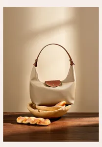 Stylish nylon shoulder bag dumpling bag for women, commuter handbag with leather handle.