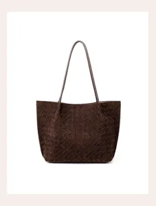 Brown suede woven shoulder bag detail showcasing the handcrafted intrecciato design pattern.