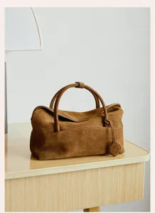 Close-up view of the vintage brown suede pillow handbag showcasing fine texture and elegant design details.