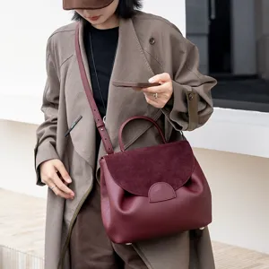 Stylish women leather shoulder bag with top handle and suede flap for daily commute use.
