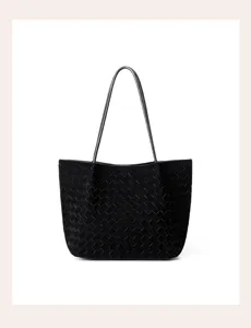 Detailed view of the black woven leather tote bag showcasing fine craftsmanship and texture.