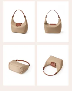 Detail view of the khaki nylon hobo bag featuring brown leather handle and snap flap closure.
