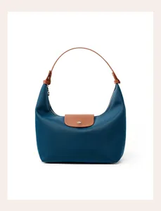 Blue nylon shoulder bag detail, stylish dumpling underarm bag with brown leather flap.