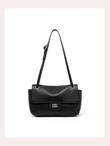 Detail shot of the black leather shoulder bag showing exquisite texture and metal twist lock.
