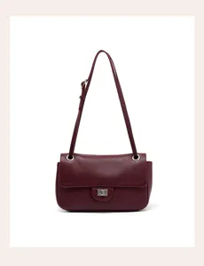 Close-up detail of the burgundy genuine leather shoulder bag showing fine texture and hardware.