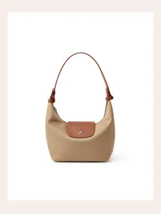 Nylon shoulder bag detail shot, classic hobo dumpling design with brown leather handle.
