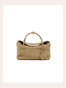 Brown suede pillow handbag detail, soft texture, vintage commuting top handle design.