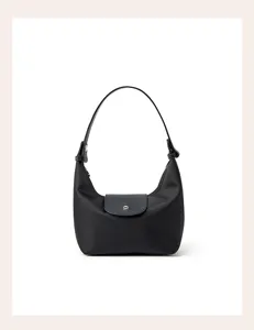Detailed view of the black nylon hobo bag featuring leather flap closure and sturdy handle.