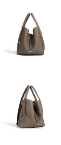 Detail view of minimalist taupe leather bucket bag, chic tote handbag for women commuting daily.