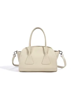 Élégant sac à main boston en cuir beige, grand sac porté épaule et bandoulière.