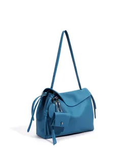 Detail close-up shot of stylish blue leather shoulder bag featuring a chic hanging pouch.