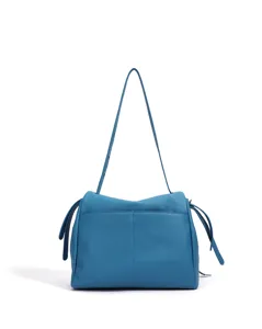 Blue leather shoulder bag detail, soft slouchy design with top zipper and side strap accents.