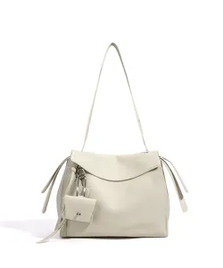 Close-up of the elegant off-white leather shoulder bag showing fine texture and charm.