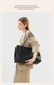 Minimalist black leather tote bag detail view, premium casual daily shoulder bag accessory.